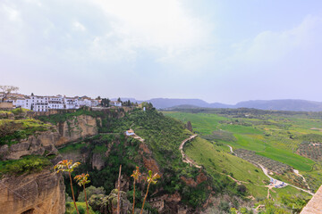 Aerial view of Ronda village, a village with white houses at the edge of cliffside in Andalusia,...