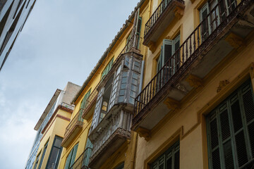 Fototapeta na wymiar Malaga, Spain, view of the eastern and modern architectures on yellow residential building