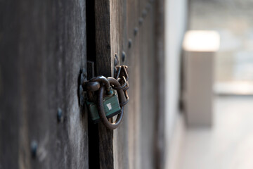 Closed lock on the old wooden door