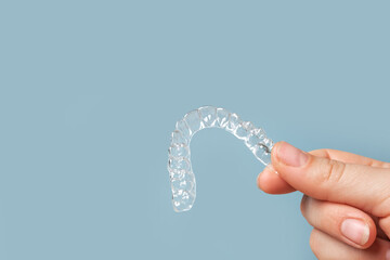 Transparent Dental Clear Aligners on Blue. Invisible Braces. Prevention Gums Treatment. Retainers for Dentistry Correction. Invisalign Orthodontics concept. Alignment of Teeth. Dentofacial Orthopedics