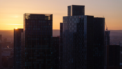 Fototapeta na wymiar Sunset view of urban Manchester skyscrapers against sky