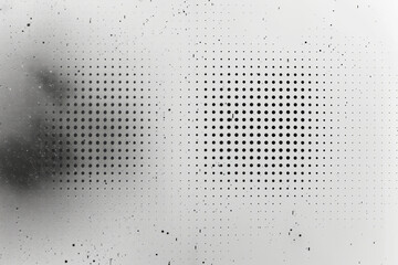 A minimalist pattern of black dots arranged in a precise square grid on a white background,