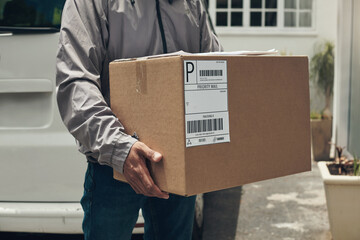 Closeup, delivery and man with box, courier and doorway with ecommerce work, distribution service...