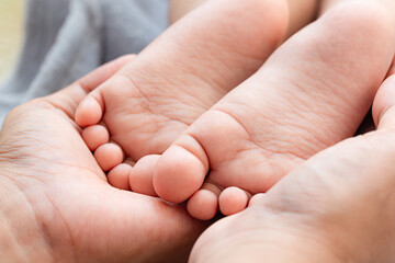 Baby feet,Parents hold in the hands and feet of the newborn baby.