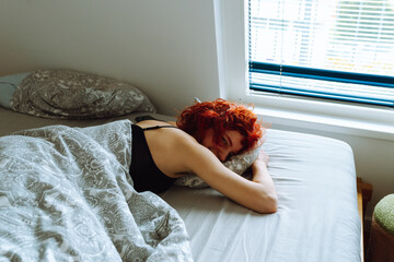 morning, young woman waking up in bed with natural hair under arms