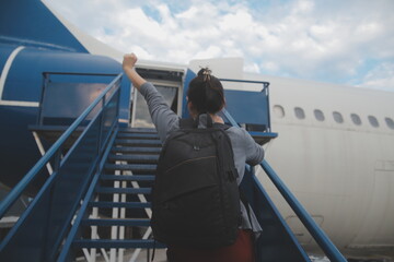 Happy attractive asian woman traveler with backpack at the modern airport terminal, copy space,...