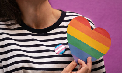 Close up of a transgender woman holding a rainbow heart.Concepts of love and acceptance for the transgender community