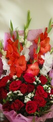 the vibrant orange lily exudes energy and vitality, with its fiery hue representing passion and enthusiasm. Both lilies captivate with their unique beauty and fragrance, each offering a distinct charm