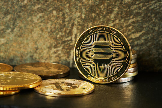 Closeup of golden Solana cryptocurrency surrounded by other cryptocurrencies and copy space