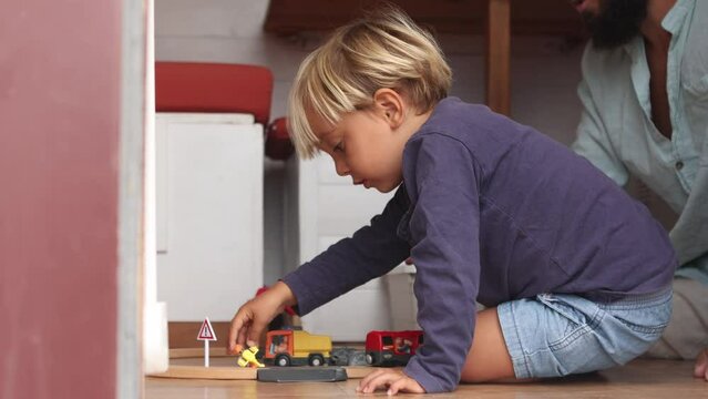 Child playing with toy trucks at home
