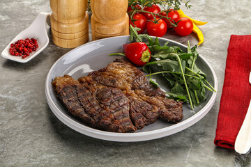 Grilled chuck roll steak with arugula