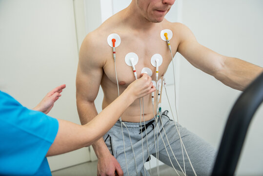 Medical professional conducting a cardiovascular evaluation with ecg electrodes