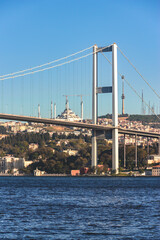 Fototapeta premium Bosporus Bridge against the backdrop of Istanbul's skyline, highlighting modern and historical fusion. Istanbul, Turkey (Turkiye)