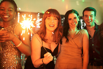 Portrait, party and friends with sparklers, celebration and excited with happiness, new year and...