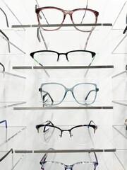 display full of glasses of all kinds and models in the opticians' shop