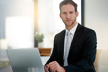 Portrait, serious and business man on laptop in office for corporate job in Switzerland. Face, confidence and professional entrepreneur on computer for research, project or agent in suit for work