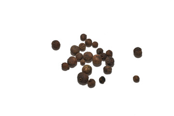 PNG. Dry allspice grains are randomly scattered across the surface, top view.