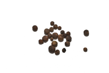 PNG. Dry allspice grains are randomly scattered across the surface, top view.