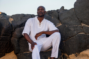 Serene African American man modeling at the beach