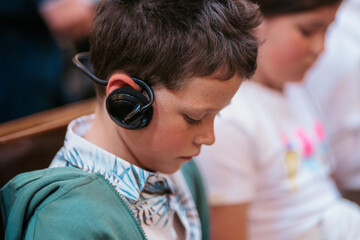 Boy with headphones in a summer classroom setting