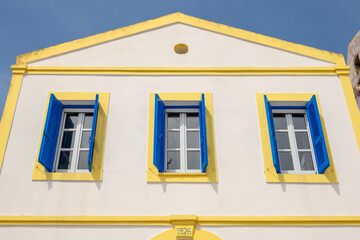 Greek whitewashed building with blue shutters in Nikia village. Nisyros island, Greece