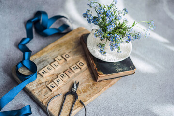Blooming forget-me-not flowers with spring greeting