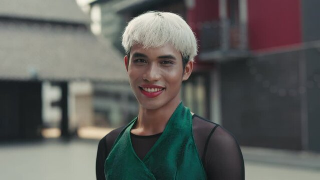 Beautiful Young T-Man Standing Outside and Looking at the Camera Wearing Stylish Clothes. Portrait of the Asian Guy with Makeup Outdoors. Diversity LGBT Concept