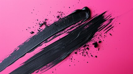 Black abstract brush strokes on pink background.