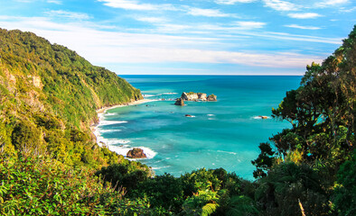 The tropical looking west coast of New Zealand's south island as seen on a bright sunny day.