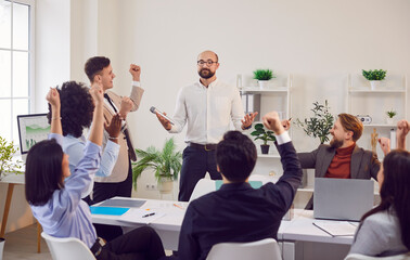 Happy and successful business team applauding to colleague during a meeting or presentation in office. Support and appreciation for colleagues contribution to the team work or strategy.