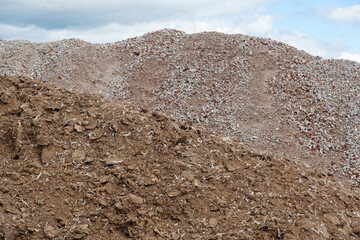 A pile of chicken manure, a large lump of rubble in the background