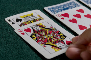 playing cards on a green felt