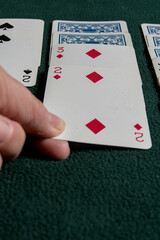 playing cards on a green felt