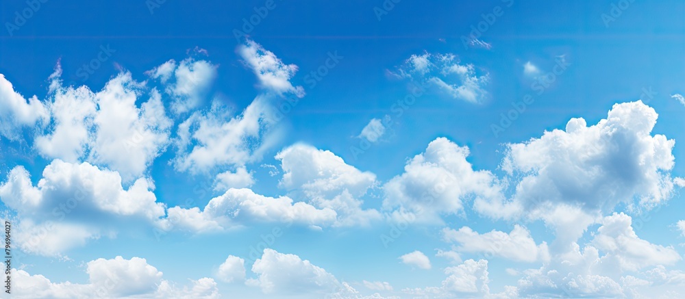 Poster Clouds over grassy field