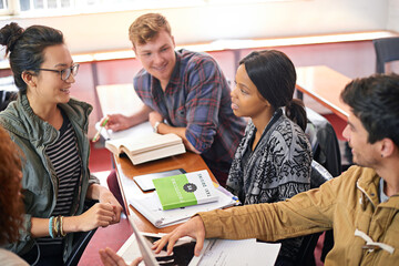 Students, group and studying in discussion with books, tablet and diversity in library for...