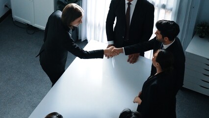 Top view of professional business team shaking hand and clapping hands to celebrate young...