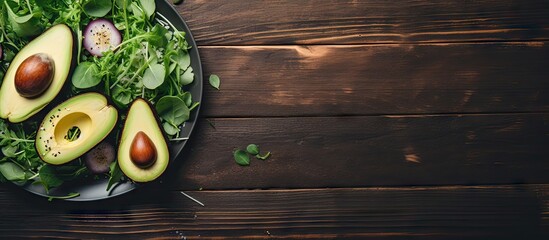 Avocado and greens on wooden table
