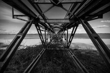 Historic steel bridge on the beach of the river Elbe.

