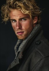 Intense young man with striking blue eyes and tousled blonde hair