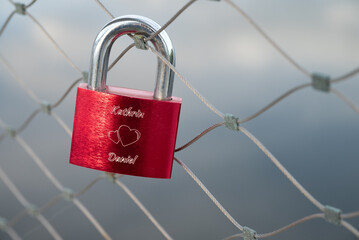 red love lock on a railing of a bridge in Deggendorf, Bavaria, Germany