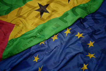 waving colorful flag of european union and flag of sao tome and principe on a euro money banknotes...