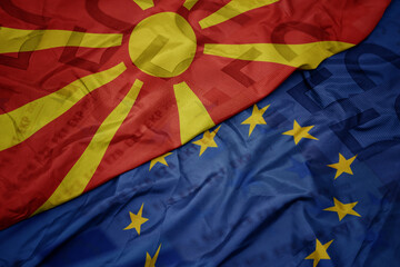 waving colorful flag of european union and national flag of macedonia on a euro money banknotes background. finance concept.