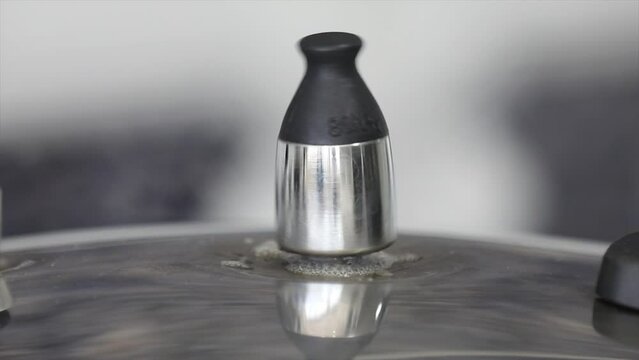 Pressure cooker in video with the valve rotating and original ambient sound.