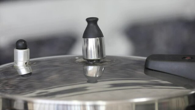 Pressure cooker in video with the valve rotating and original ambient sound.