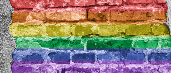 Rainbow LGBT banner. Lesbian, gay, bisexual, and transgender pride flag on brick wall background.