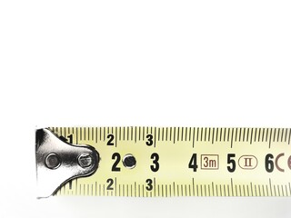 Close-up of a yellow metal measuring tape extended, showing six centimeters - obrazy, fototapety, plakaty