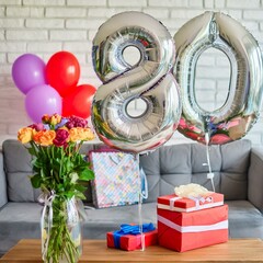 Birthday surprise silver helium balloons number 80 with flowers and colorful wrapped gifts inside a bright cozy living room