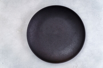 Empty black plate on light gray