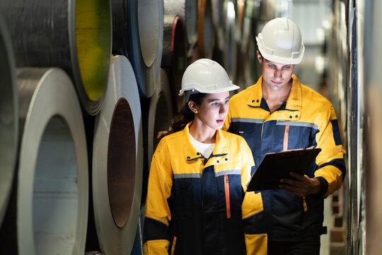 Portrait of Two Professional Engineers Use Industrial Digital Tablet to Work with Augmented Reality. Great Template Shot for Augmented Reality. Factory Workshop. engineer man and woman manager leader