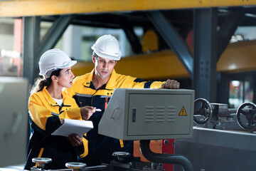 professional engineer,worker,technician use clipboard discuss work, walk in steel metal manufacture...